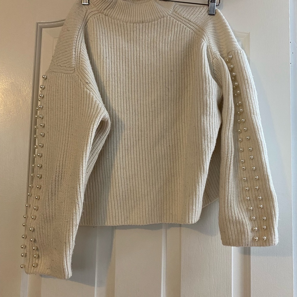 Womens sweater with pearls on the sleeves